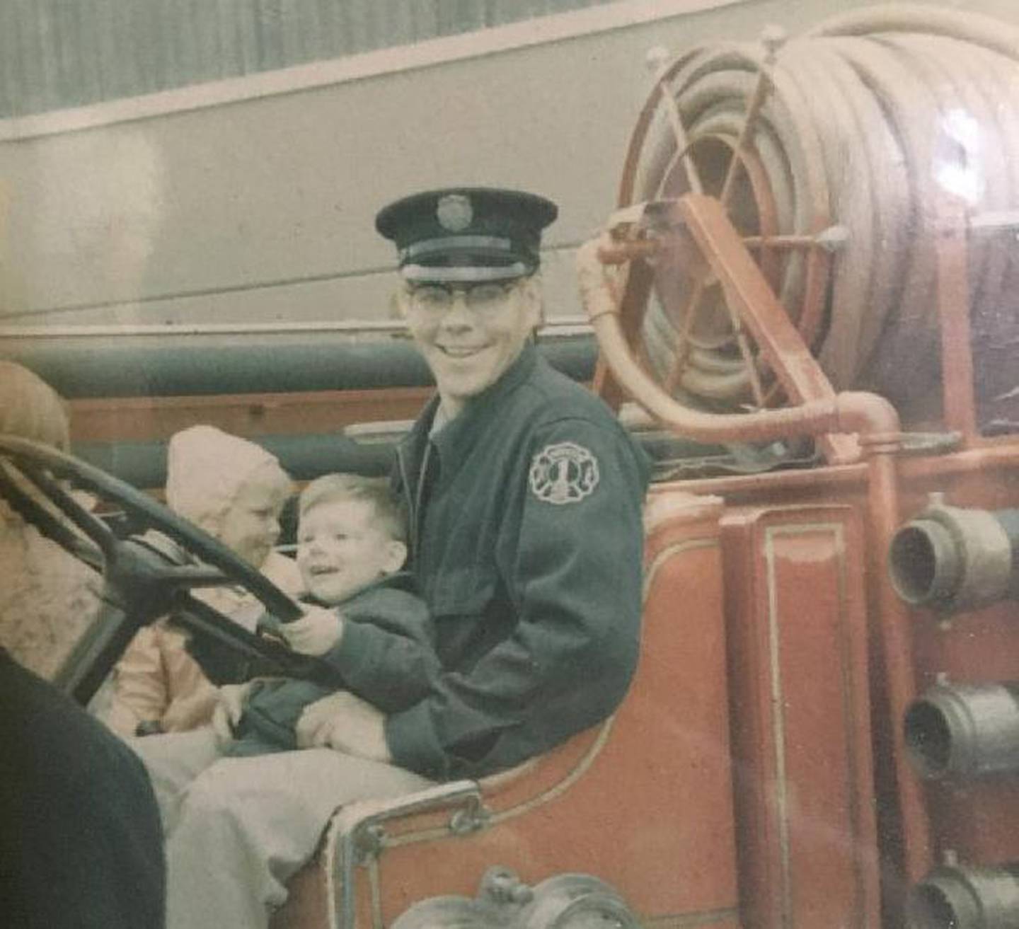 Jeff VanPatten is pictured on his father, Jerry's, lap with an unidentified child. The family's 108-year tradition with Antioch's fire department has ended with Jeff's retirement after 35 years.