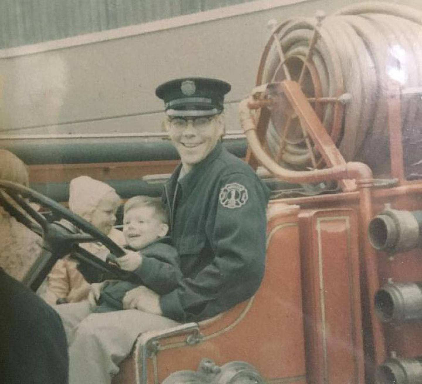 Jeff VanPatten is pictured on his father, Jerry's, lap with an unidentified child. The family's 108-year tradition with Antioch's fire department has ended with Jeff's retirement after 35 years.