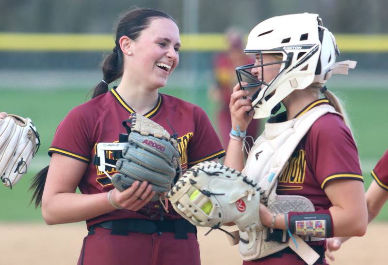 Richmond-Burton’s Hailey Holtz, left, and Rebecca Lanz  celebrate the final out against Marengo in varsity softball on Tuesday, April 22, 2025, at Marengo High School in Marengo.