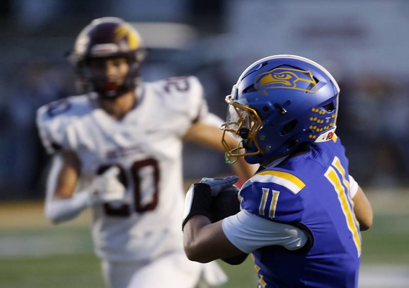 Johnsburg's Ryan Franze catches a touchdown pass in front of Richmond-Burton's Luke Johnson during a Kishwaukee River Conference football game on Friday, Sept. 12, 2025, at Johnsburg High School.