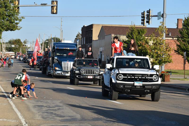 Parade goers gather candy along Main Street on Wednesday, Oct. 2, 2024, during the Streator High School homecoming parade.