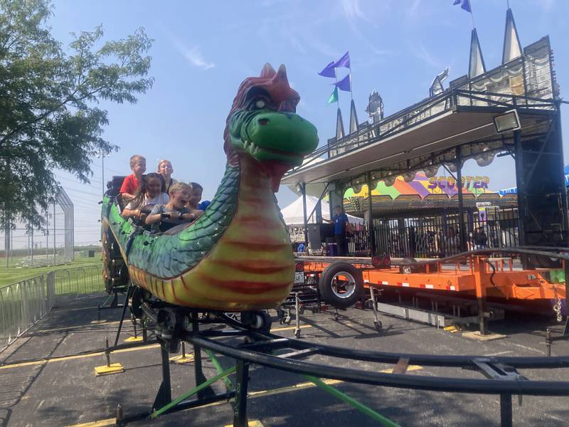 Children ride the "dragon wagon" kids coaster at the Shorewood Crossroads Festival Carnival on Saturday, August 2, 2025.
