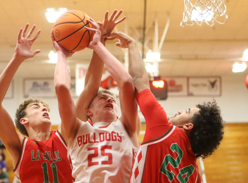 Streator's Joseph Hoekstra eyes the hoop as L-P's Jameson Hill and Marion Persich defend on Tuesday, Jan. 13, 2026 in Pops Dale Gymnasium at Streator High School.