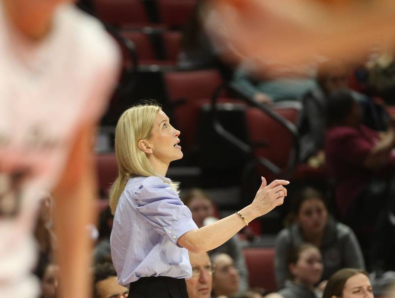 Montini Catholic head girls basketball coach Shannon Spanos glances up at the score board late in the fourth quarter while playing Quincy Notre Dame during the Class 3A State semifinal game on Thursday, March 6, 2025 at CEFCU Arena in Normal.