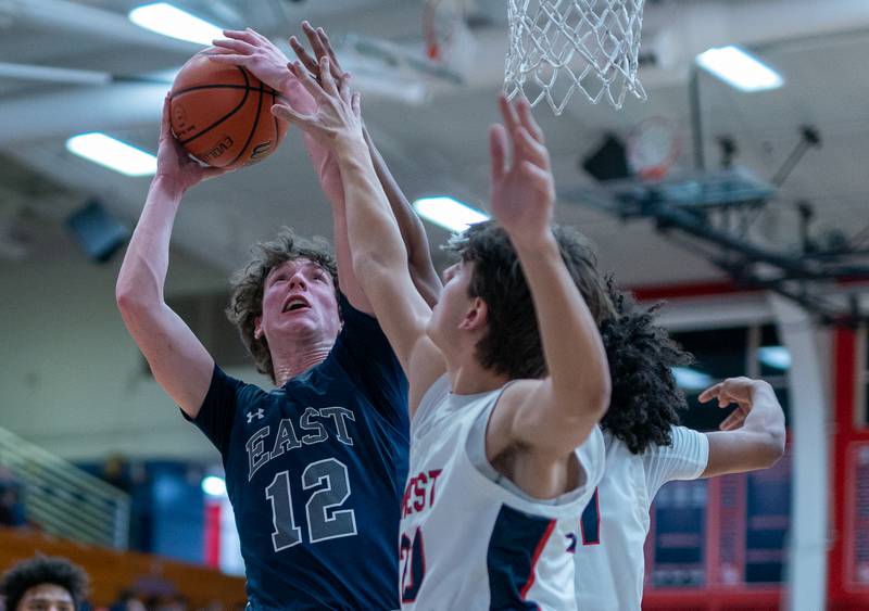 Oswego East's Ryan Johnson (12) shoots the ball in the post against West Aurora during a basketball game at West Aurora High School on Friday, Jan 27, 2023.
