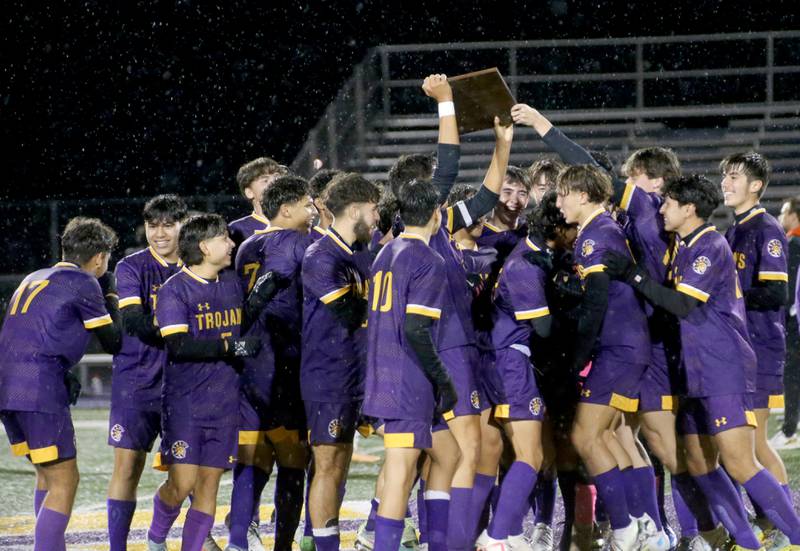 Members of the Mendota boys soccer team hoist the Class 1A Regional plaque after defeating Kewanee 4-0 on Wednesday Oct. 18, 2023 at Mendota High School.