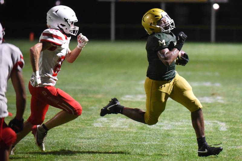 Bishop McNamara's Julius May, right, runs past Streator's Quentin Stevens during a Week 0 scrimmage at Bishop McNamara Friday, Aug. 22, 2025.