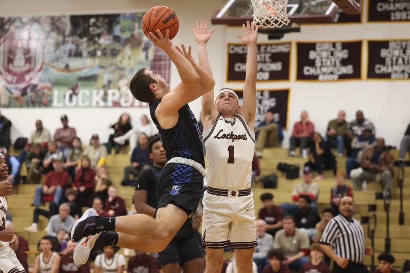 Lincoln-Way East’s Luke Vetter puts up a shot against against Lockport’s Bryce Turner  on Friday, Dec. 1, 2023 in Lockport.