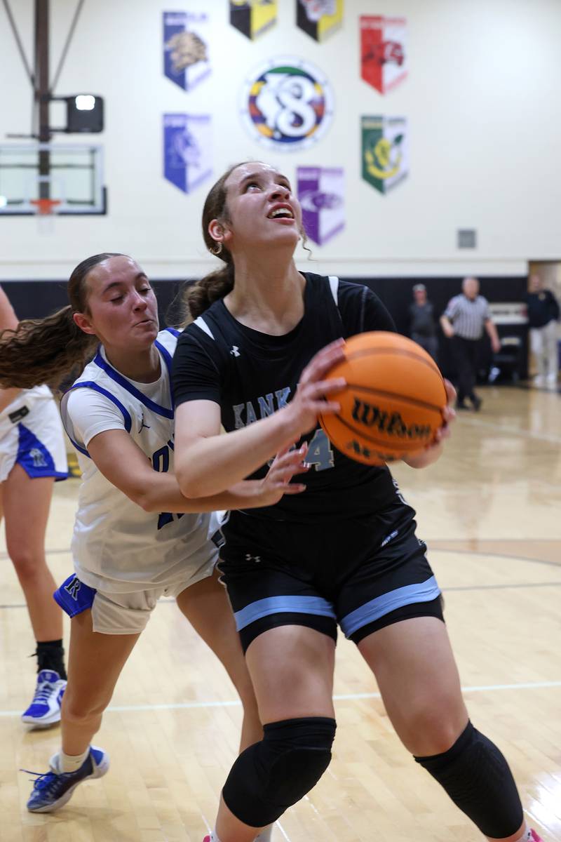 Kankakee's Ava Johnson looks to shoot after a rebound against Rosary's Zoe Mesner during the Kays' 75-28 victory over Rosary at the Reed-Custer Classic on Monday, Nov. 17, 2025.