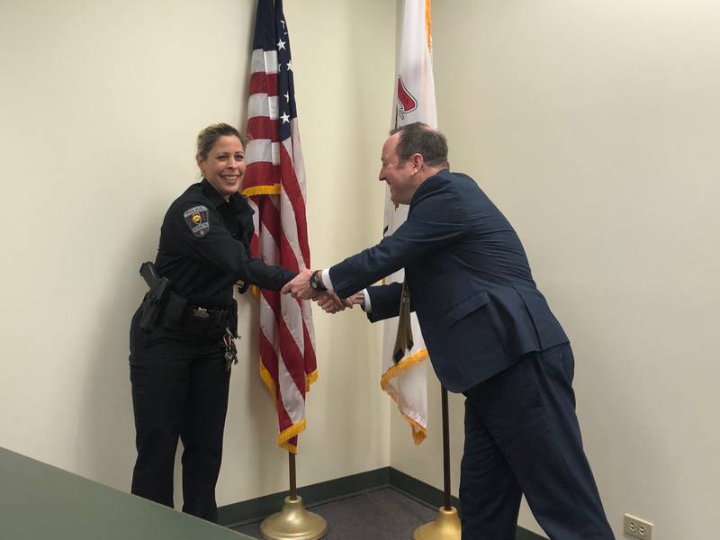 Juanita Gumble, left, is congratulated by Hebron village attorney Michael Smoron after she was sworn in as the new Hebron chief of police on Monday, Jan. 30, 2023.