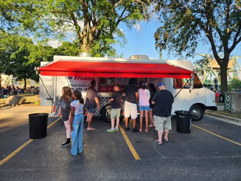 People line up at the Tacos Maui food truck from Joliet at the Independence Celebration on Thursday, July 3, 2025, at the Billie Limacher Bicentennial Park & Theatre in Joliet.