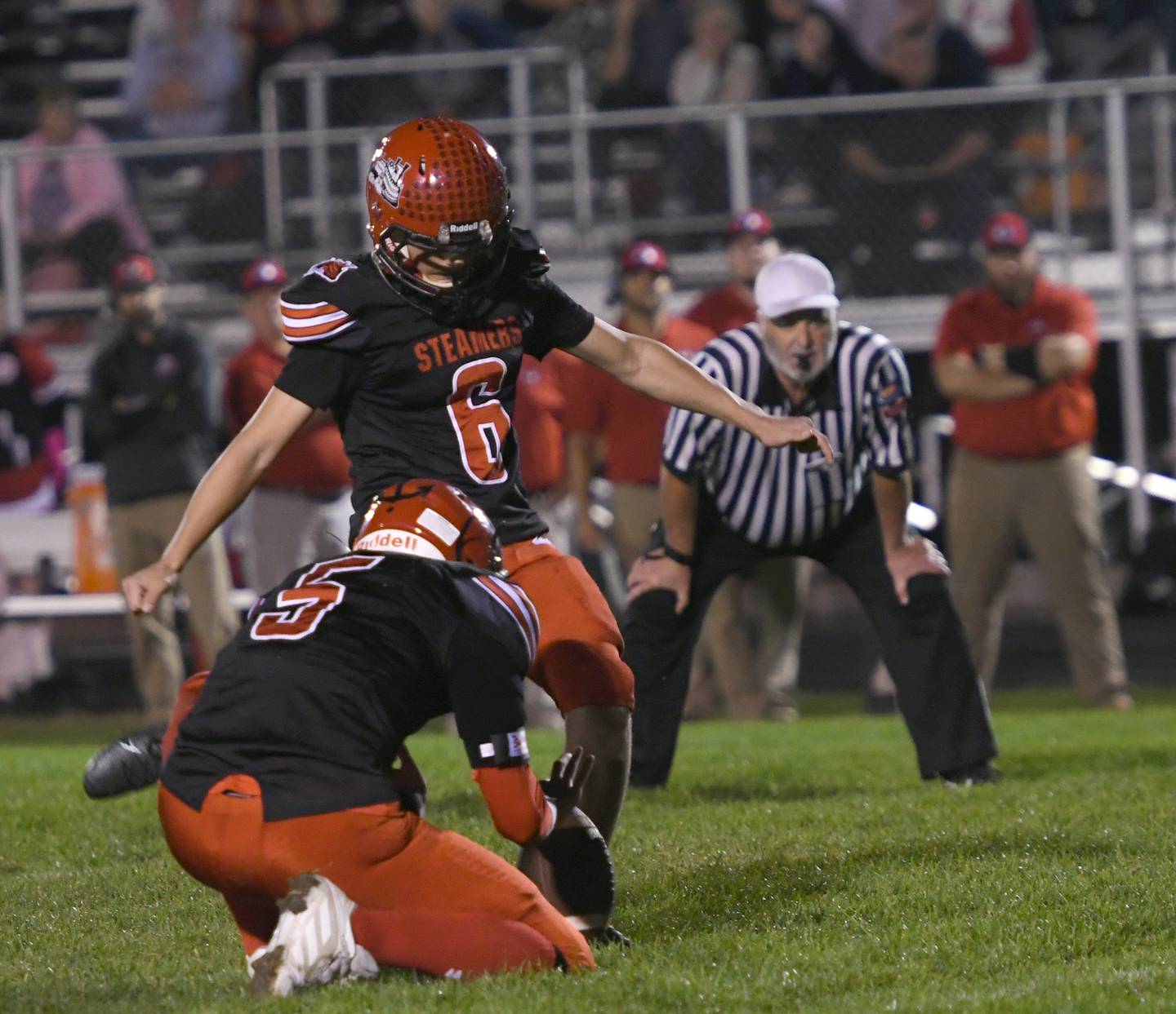 Fulton's Endi Quanaj plants to kick a field goal as Brayden Dykstra holds.