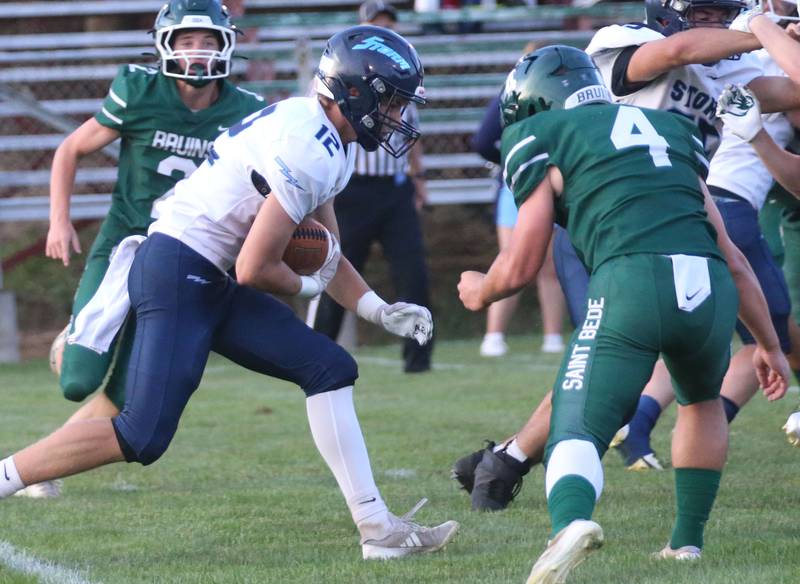 Bureau Valley's Brandon Carrington runs the ball as St. Bede's AJ Hermes looks to make a tackle on Friday Aug. 29, 2025 at St. Bede Academy.