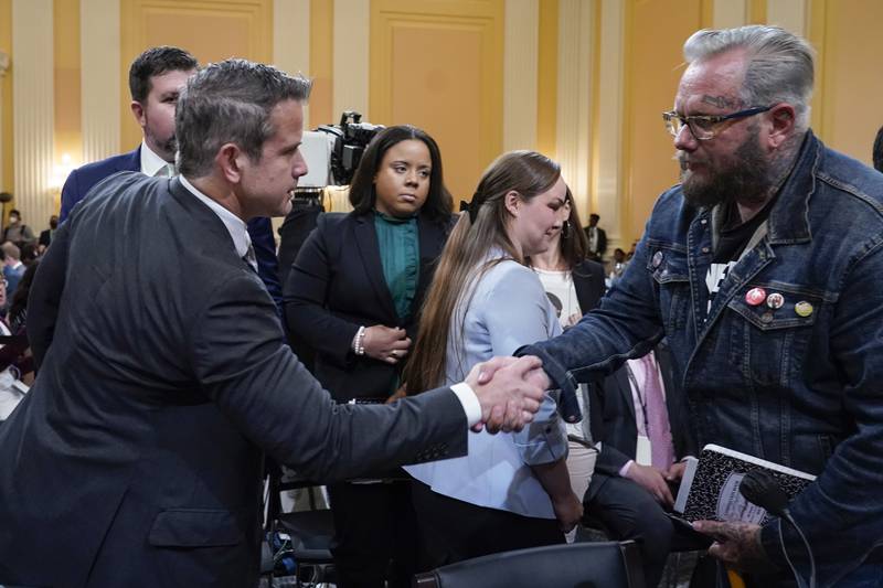 Rep. Adam Kinzinger, R-Ill., shakes hands with Jason Van Tatenhove, an ally of Oath Keepers leader Stewart Rhodes, as the hearing with House select committee investigating the Jan. 6 attack on the U.S. Capitol ends at the Capitol in Washington, Tuesday, July 12, 2022. (AP Photo/Jacquelyn Martin)