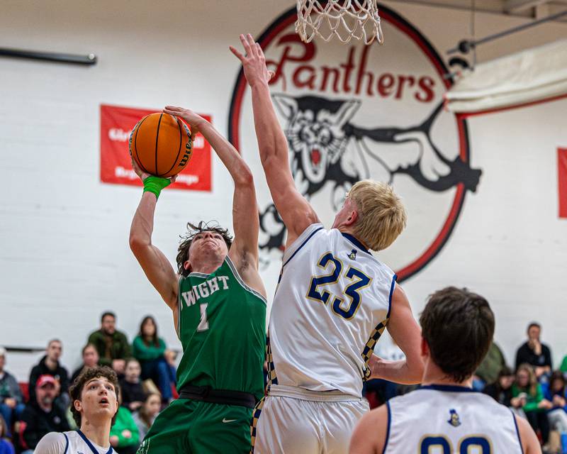 Dwight's Joe Duffy (1) leaps into Marquette's Luke McCullough (23) as he lays up ball on Saturday, Feb. 21, 2026 at Marseilles Elementary School.