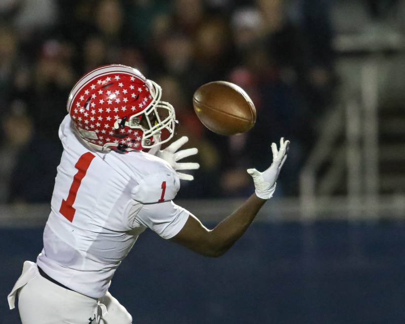 Naperville Central's DeShaun Williams (1) catches a pass over the middle and ran it in for a touchdown during Class 8A quarterfinal football game between Naperville Central at Lyons on Friday, Nov 15, 2024  in Western Springs.