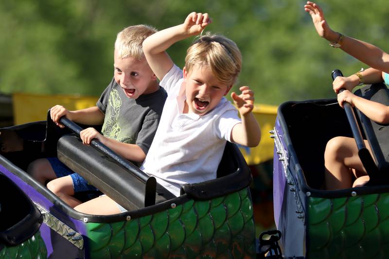 Christian King, left, and Hudson Everard, both 5, enjoy a ride on a roller coaster during the annual Lakeside Festival at the Dole and Lakeside Arts Park on Thursday, July 1, 2021, in Crystal Lake.