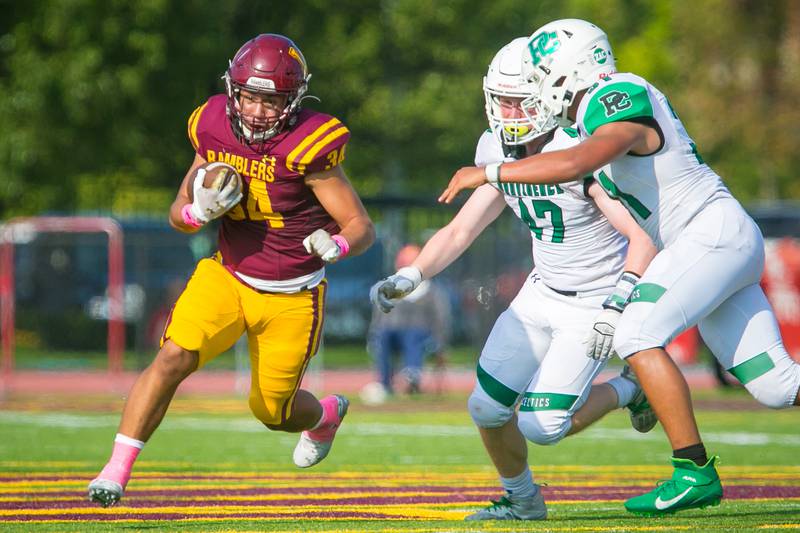 Loyola Academy running back Jared Otarola (34) runs the ball during the football game at Loyola Academy High School on Saturday, Oct. 9, 2021. The Ramblers won, 40-0.
