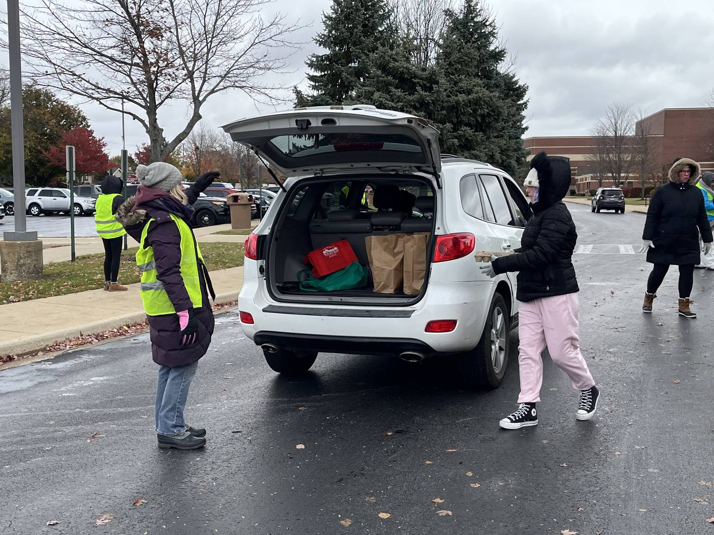 Volunteers deliver food during a community food drive outside the east campus for Lockport Township High School District 205 on Sunday, Nov. 9, 2025.