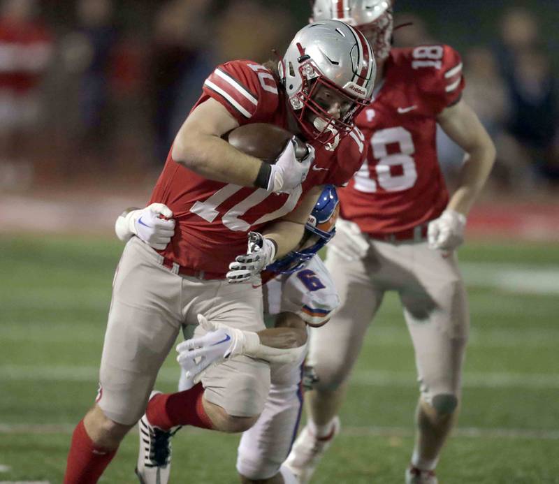 Palatine's Nate Branch (10) slips past Hoffman Estate's Jayleon Johnson (6) Friday October 21, 2022 in Palatine.