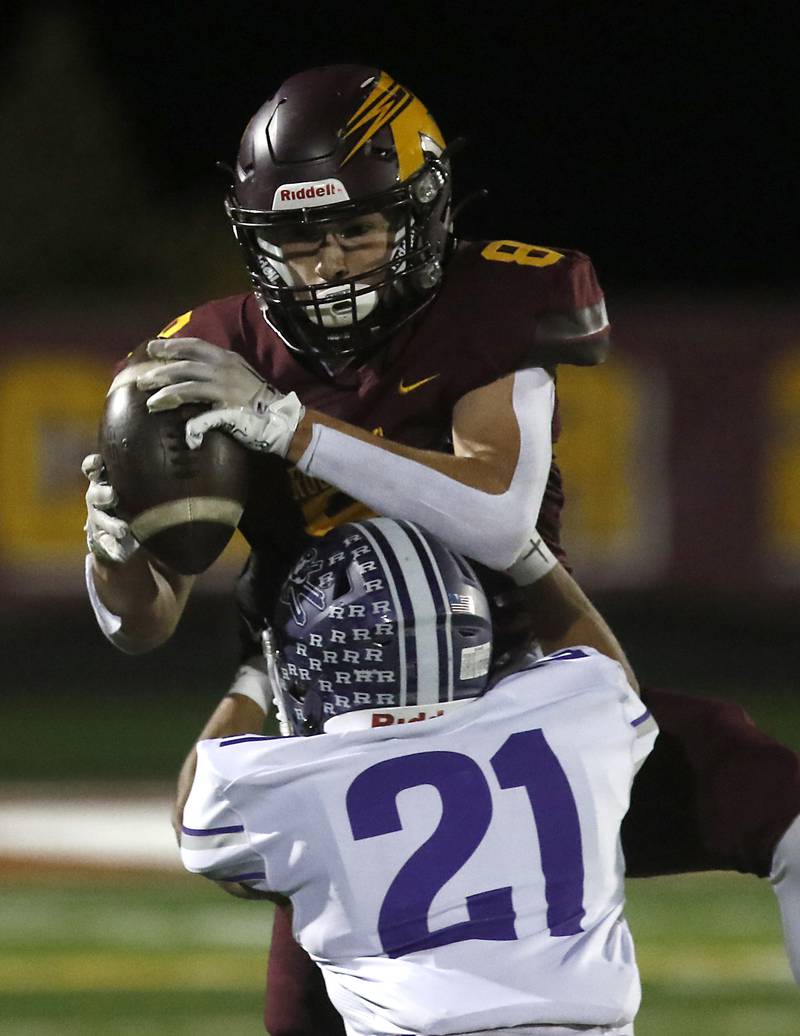 Richmond-Burton's Jack Martens catches a pass over Rochelle's Xavier Villalobos during a Kishwaukee River Conference football game on Friday, Oct.20, 2023, at Richmond-Burton High School.