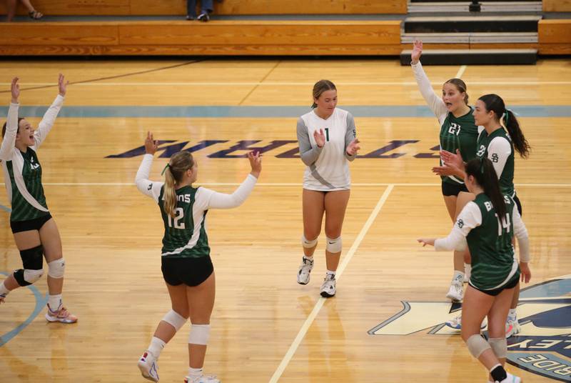Members of the St. Bede volleyball team react after defeating  Bureau Valley in the second set on Tuesday, Sept. 5, 2023 at Bureau Valley High School.