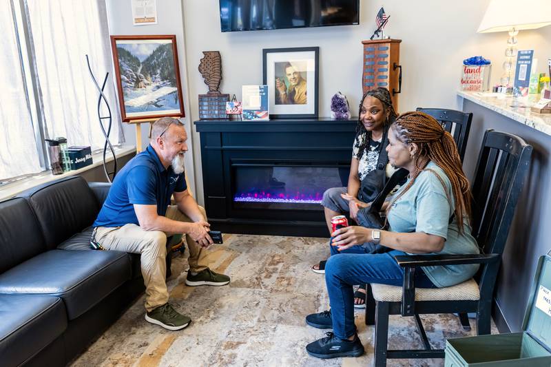 Marty Rielage, Roslynn Hopkins, and Gwen Barnett chat during AllenForce's grand opening event which introduced the community to the new Veteran Wellness & Recreation Center in Joliet on July 25, 2025.