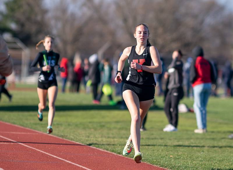 Yorkville’s Anna Hunter competes in the 4 x 800 meter relay race during the Matt Wulf Invitational track and field meet at Yorkville High School on Thursday, April 14, 2022.