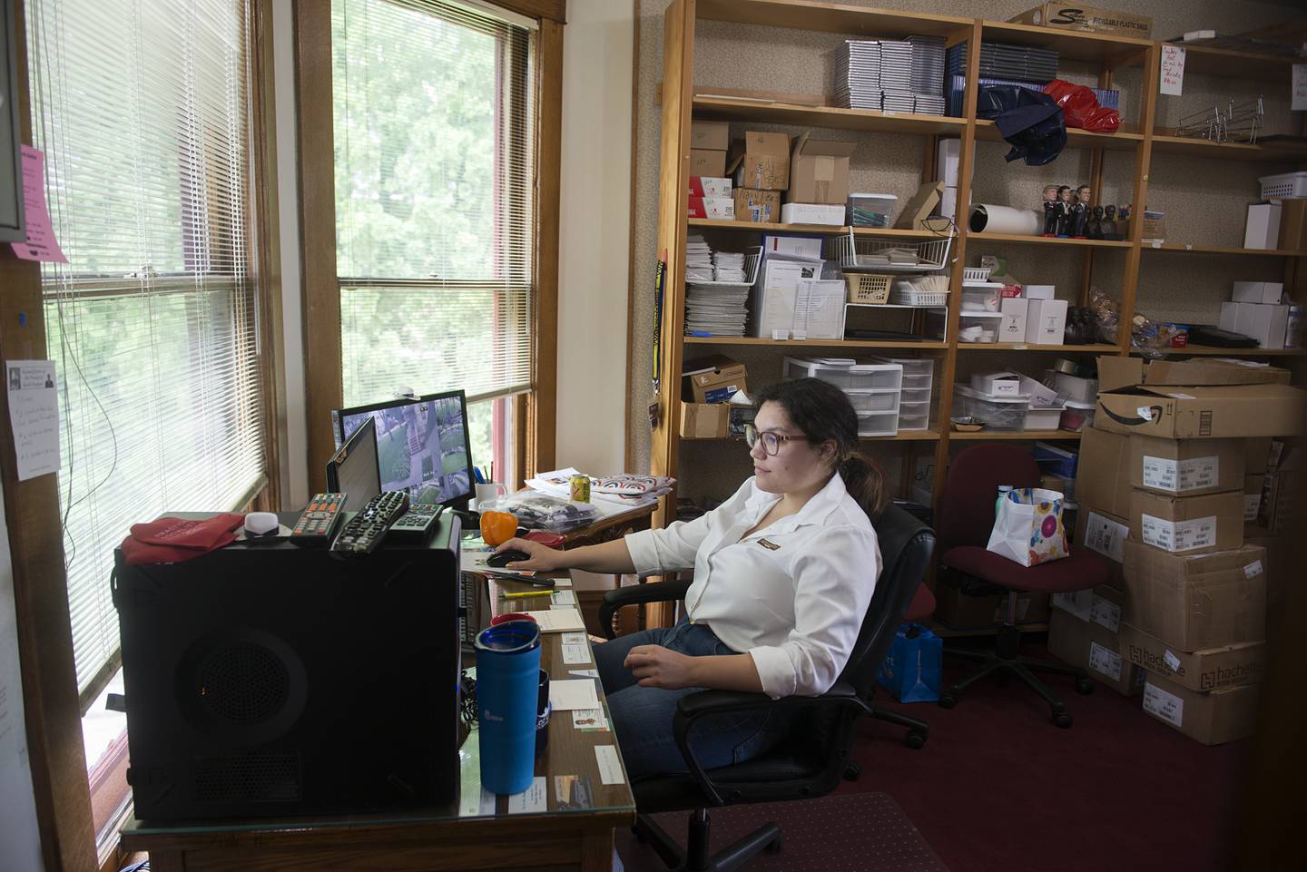 Intern archivist Julia Wooldridge works in the office of the welcome center of the Reagan Boyhood Home on Thursday, July 15, 2021.