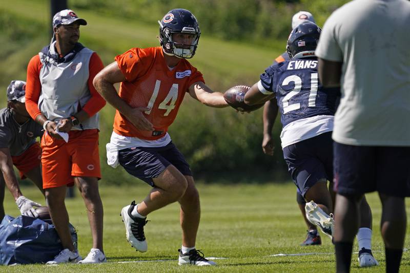 Chicago Bears quarterback Nathan Peterman hands off the ball to running back Darrynton Evans during the team's training camp, Saturday, July 30, 2022, in Lake Forest.