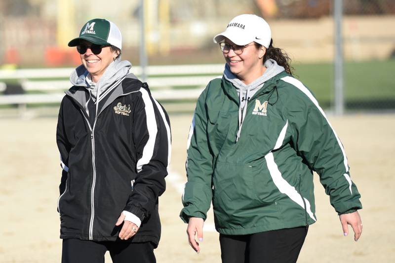 Bishop McNamara assistant softball coach Drew Dunlap, left, and head coach Alee Rashenskas are all smiles following a 15-0 win over Aurora Christian at home Tuesday, April 8, 2025.