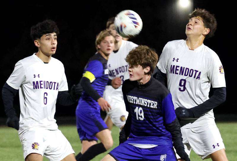Harvest-Westminster's Alex Miron heads the ball between Mendota's Danny Garcia (left) and Abel Nanez Friday, Oct. 31, 2025, during the Class 1A Indian Creek Sectional championship game Friday in Waterman.