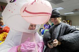 Party time!: Dixon moms don blow-up gear to celebrate their graduating seniors