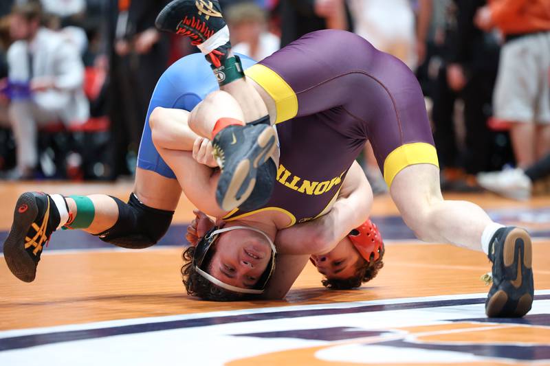 Montini's Isaac Mayora, near, is flipped by Marmion Academy's Logan Conover in the 144-pound match during Marmion Academy's victory over Montini in the IHSA Class 3A Dual Team State championship on Saturday, Feb. 28, 2026.