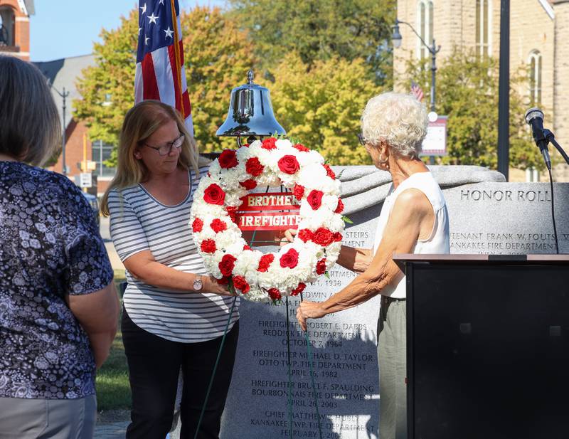 Denise Spaulding, left, of Bourbonnais, wife of fallen Bourbonnais Fire Department firefighter Bruce Spaulding, and Linda Taylor-Gerretse, former wife of fallen Otto Township firefighter Michael Taylor, help place the wreath during the 44th Kankakee County Fallen Firefighter Memorial Service on Friday, Oct. 3, 2025.