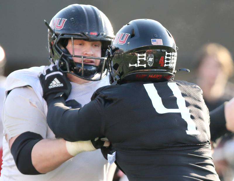 Northern Illinois University offensive lineman Nolan Potter (left) blocks defensive end Raishein Thomas during spring practice Friday, April 7, 2023, in Huskie Stadium at NIU in DeKalb.