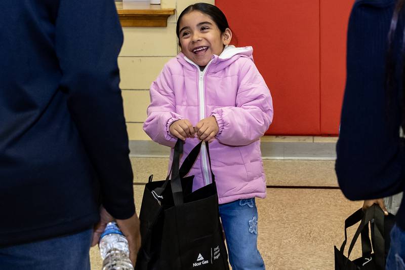 First grader Valentina Guzman smiles while chatting with Nicor representative during the winter coat event hosted by Nicor Gas, in collaboration with Operation Warm, at T. E. Culbertson Elementary School on Nov. 7, 2025.