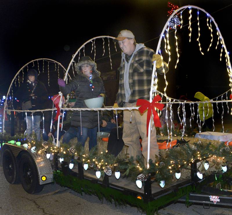 hose on the Land Of Lincoln UTV Association floats, toss out candy treats to those along Main St Saturday annual Holiday Magic Lighted Santa Parade in Marseilles.