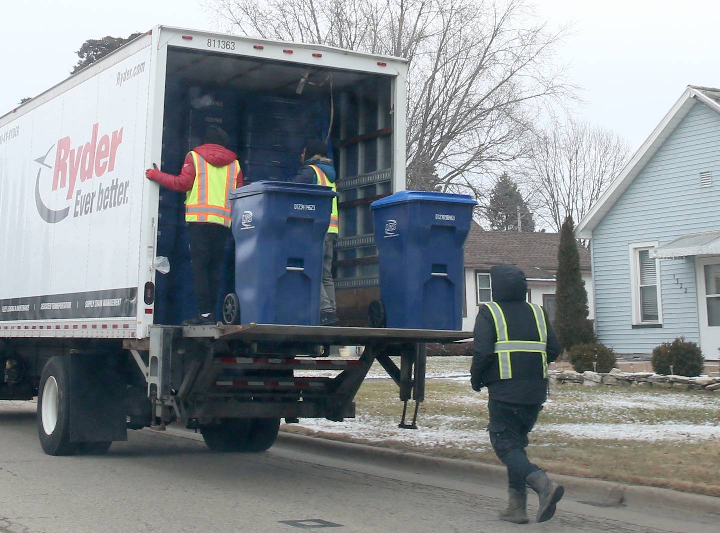 Employees with Lakeshore Recycling Services distribute garbage and recyclable containers to homes along Chartres Street on Monday, Jan. 23, 2023 in La Salle. The rate will go from $14.50 per month to $20 per month with LRS. LRS is based out of Chicago, but it has a branch in Monmouth where La Salle residents will get their service.