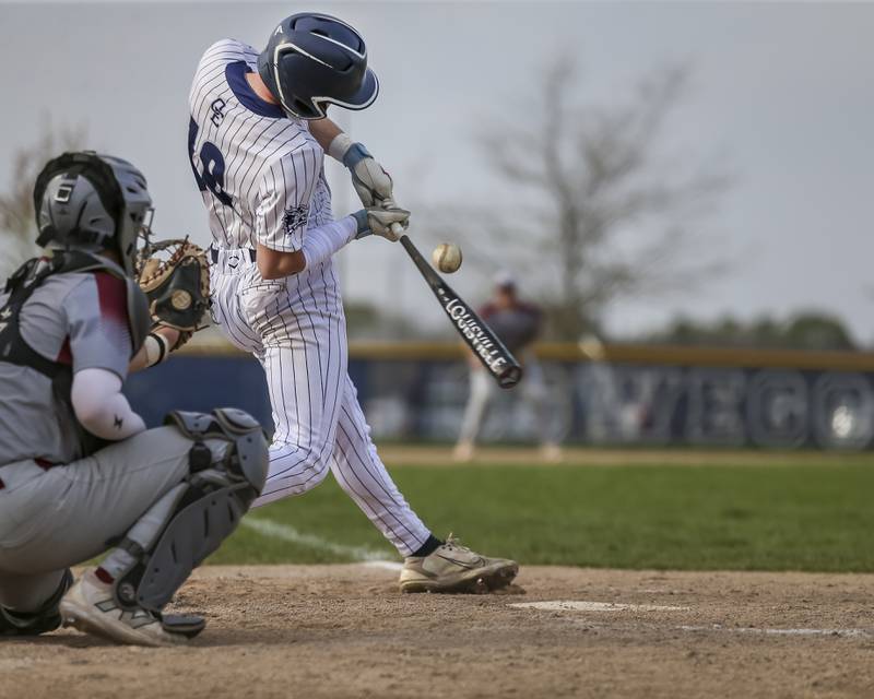 Oswego East's TJ Anderson (18) fouls off a pitch during baseball game between Plainfield North at Oswego East, Monday, April 28, 2025 in Oswego.