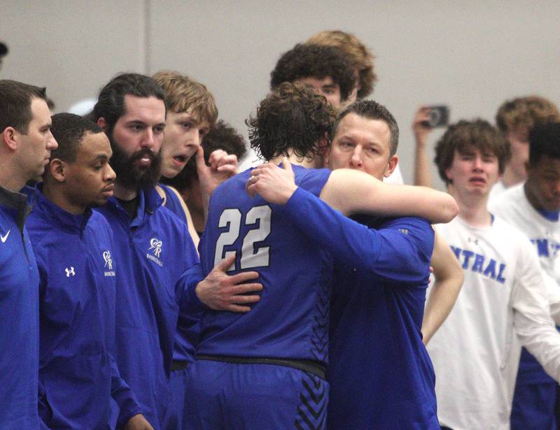 Burlington Central Head Coach Brett Porto embraces Nick Gouriotis late in the Rockets’ loss to Marmion Academy in IHSA Class 3A Sectional title game action at Burlington Central High School Friday night.