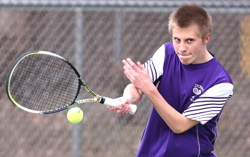 Dixon’s Derek Miller hits a forehand during his number one doubles match along with partner Owen Winter against Sycamore Thursday, March 30, 2023, at Sycamore High School.