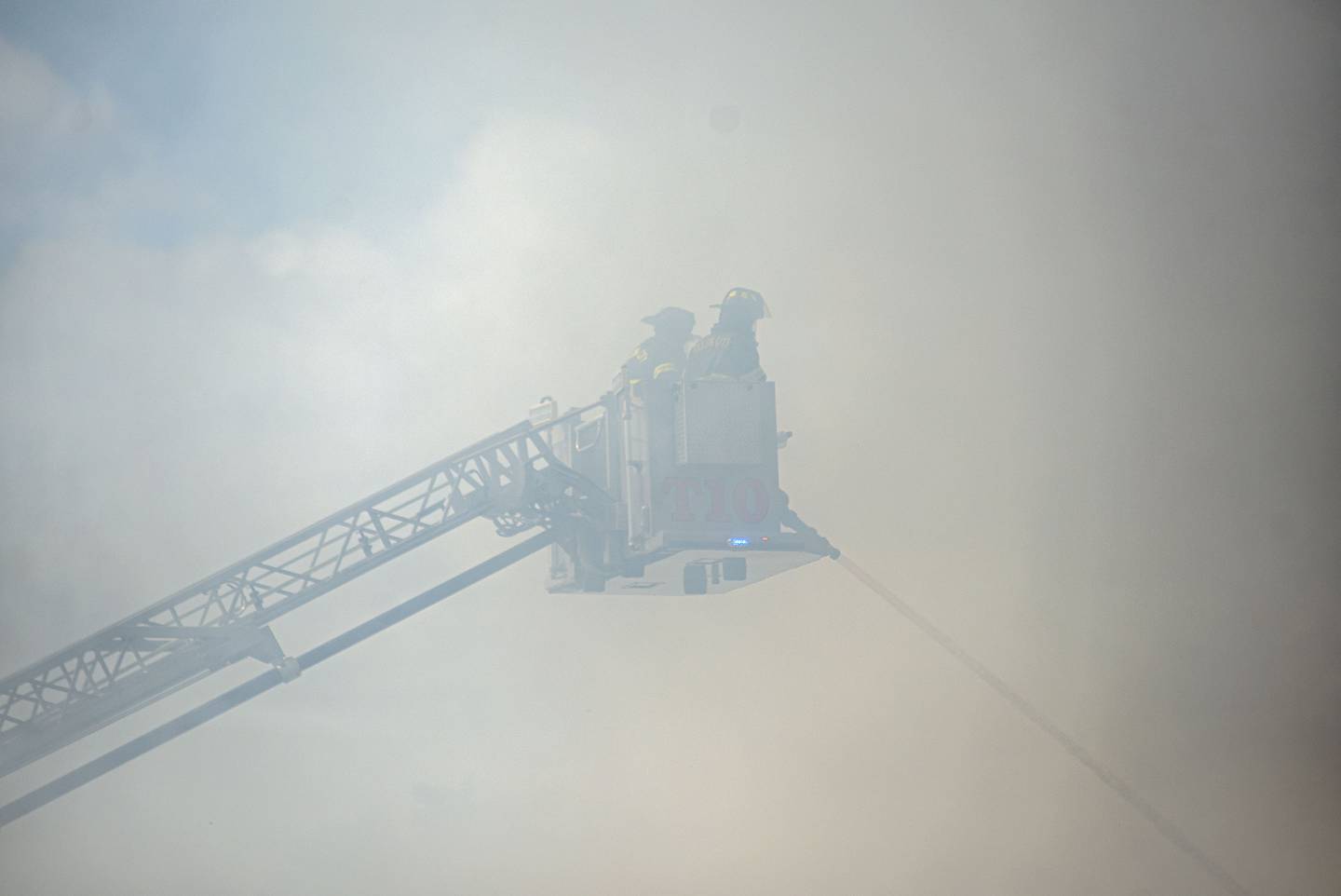 Heavy smoke obscures firefighters as they battle a blaze from a Snorkel truck Monday, Sept. 26, 2022 in Dixon.