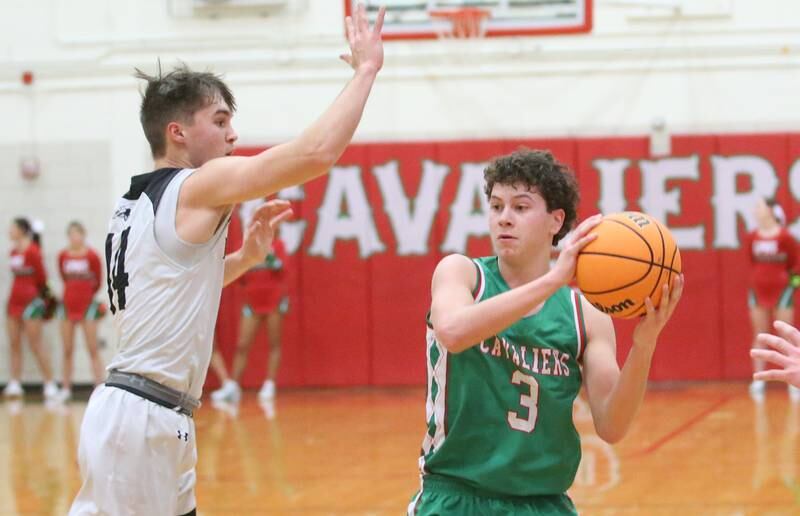 L-P's Mikey Hartman passes the ball around Kaneland's Preston Popovich on Friday, Jan. 31, 2025 in Sellett Gymnasium at L-P High School.