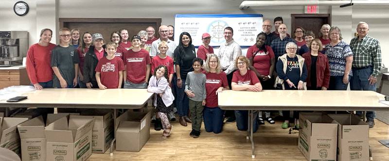 Volunteers gathered at the Evangelical Free Church of Mt. Morris on Thursday, Oct. 16, 2025 to fill boxes with care packages to be mailed to sailors on the USS Fitzgerald.