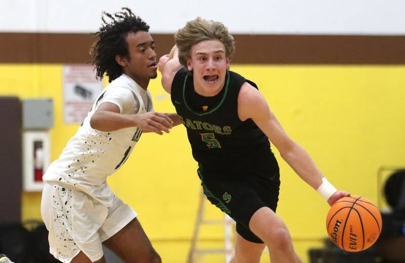 Crystal Lake South’s Carson Trivellini drives past Grayslake Central’s Alex Granville during Hinkle Holiday Classic varsity boys basketball tournament action on Thursday, Dec. 26, 2024 at Jacobs High School in Algonquin.
