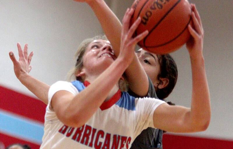 Marian Central’s Madison Kenyon is fouled by Rockford Guilford’s Nadia Barbour in varsity girls basketball Saturday at Landers Pavilion on the campus of Marian Central High School in Woodstock.