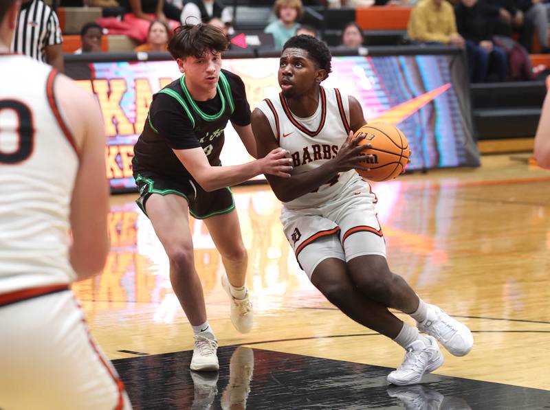 DeKalb's Myles Newman tries to drive by Rock Falls' Phillip Griffith Jr. during their game Tuesday, Dec. 2, 2025, at DeKalb High School.
