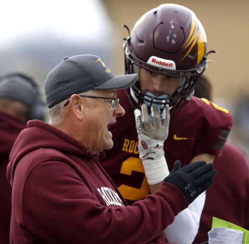 Richmond-Burton Head Coach Mike Noll talks with Jace Nelson during an IHSA Class 3A semifinal playoff football game against Byron on Saturday, November 22, 2025, at Richmond-Burton High School, in Richmond.