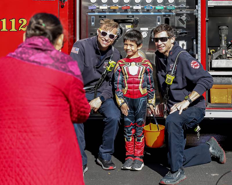 The La Grange Fire Department pose with their favorite superhero at the La Grange Trunk or Treat event.  Oct 21, 2023